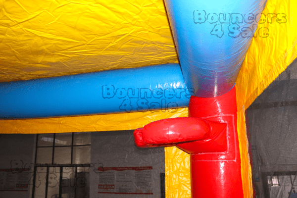 A red and blue inflatable castle with yellow walls.