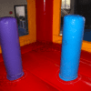 Two blue and purple pillars in a red room.