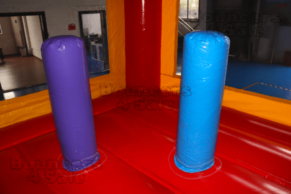 Two blue and purple pillars in a red room.