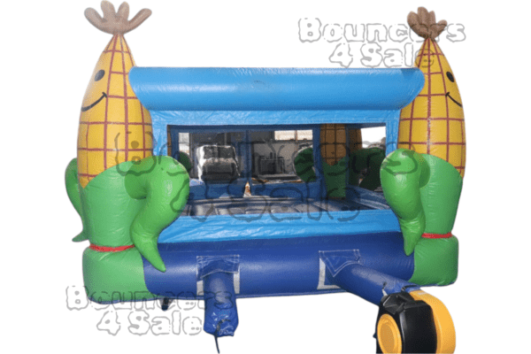 A blue and green inflatable bouncer with corn on the cob.