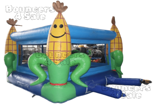 A inflatable corn shaped bounce house with two large green bananas.