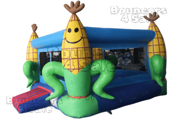 A corn shaped bounce house with two people inside.