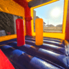 A bounce house with two red and yellow pillars.