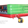 A green and red inflatable obstacle course with a light.