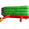 A green and red inflatable slide with a handle.
