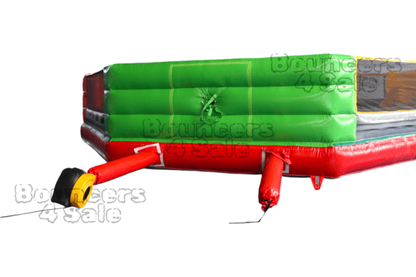 A green and red inflatable slide with a handle.