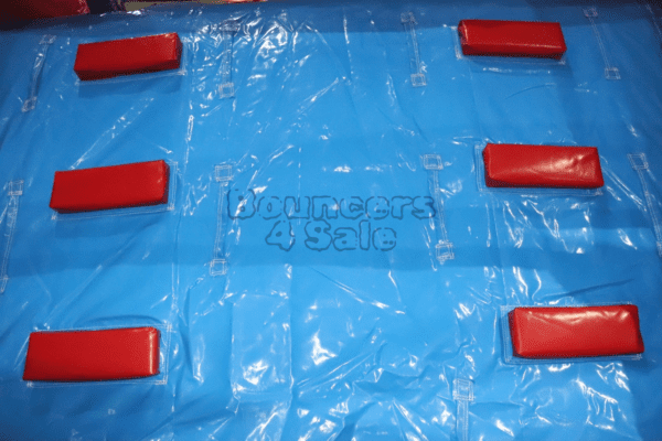 A blue tarp with red blocks on it.