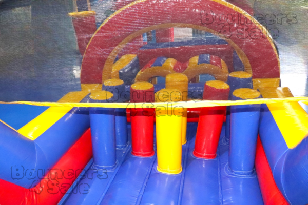 A bouncy castle with obstacles on it