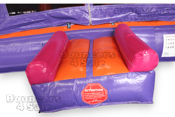 A purple and orange inflatable obstacle course.