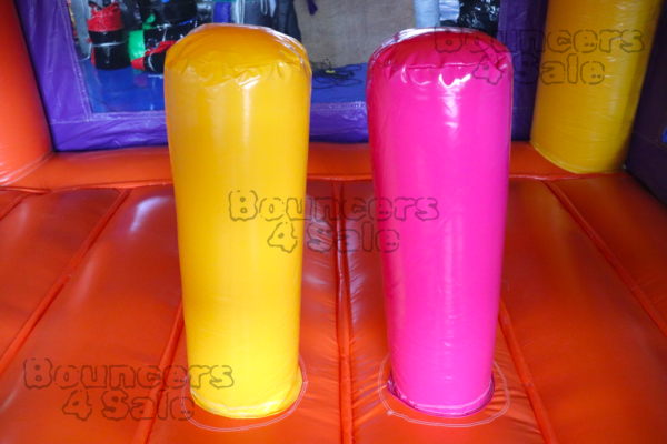 Two yellow and one pink cups on a table.