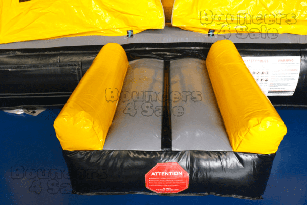 A black and yellow inflatable obstacle course.