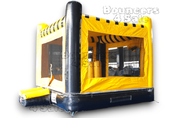 A yellow and black bounce house with windows.