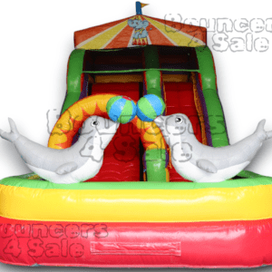 A inflatable slide with two white seals on it.