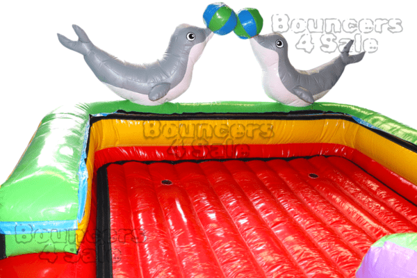 A bouncy house with two seals on it.