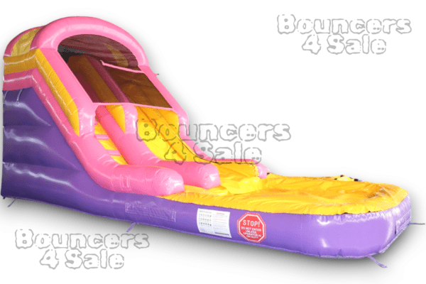 A pink and yellow inflatable slide on top of purple ground.