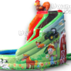 A large inflatable slide with farm animals and trees.
