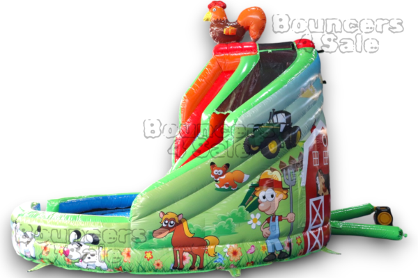 A large inflatable slide with farm animals and trees.