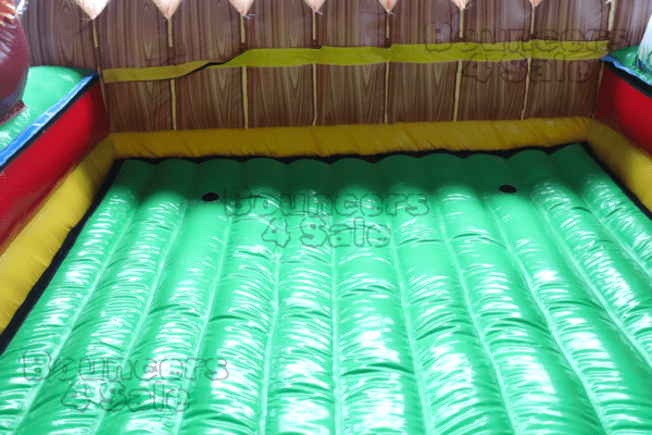 A green mattress in the middle of a room.