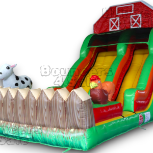 A inflatable slide with farm animals and fence.