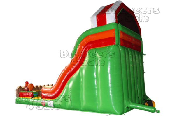 A green and red inflatable slide with a tower.