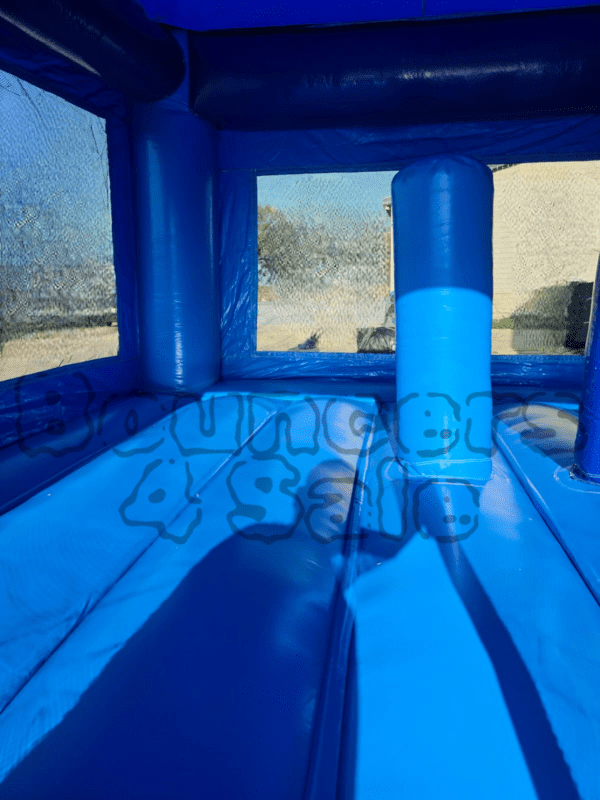 A blue inflatable castle with a slide.