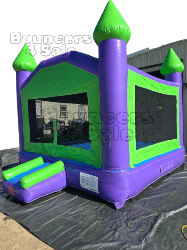 A purple and green bounce house with steps.