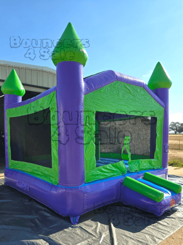 A purple and green castle bounce house.