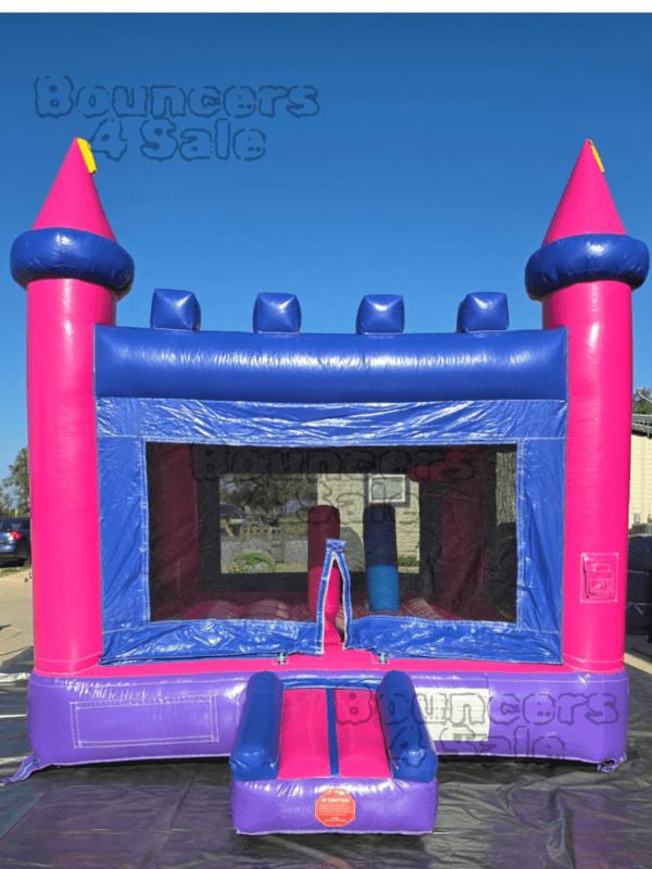 A pink and blue castle bounce house.