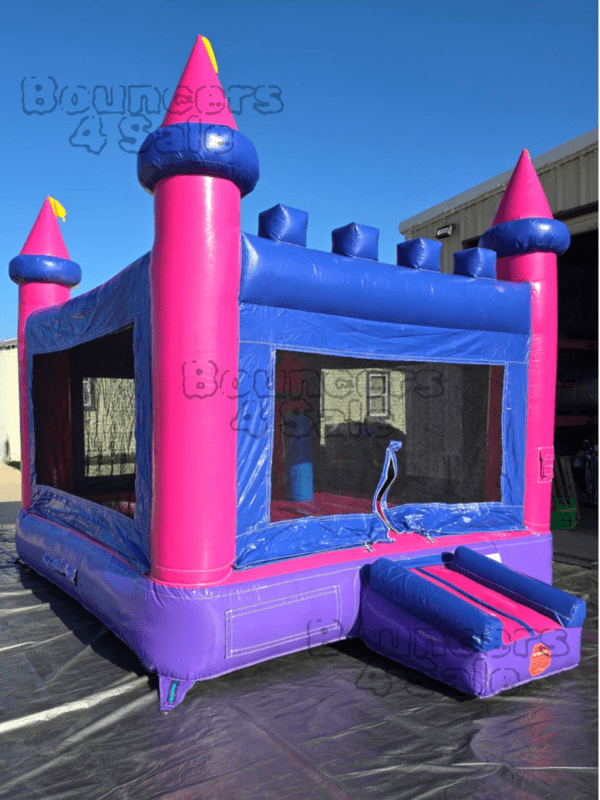 A pink and blue castle bounce house.