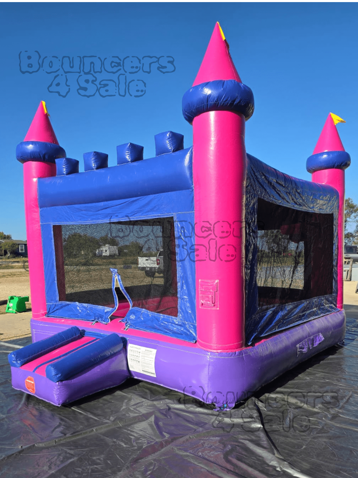 A pink and purple castle bounce house.