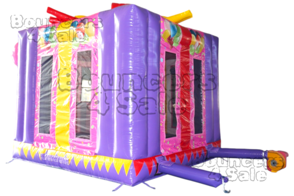 A purple inflatable party house with balloons on it.